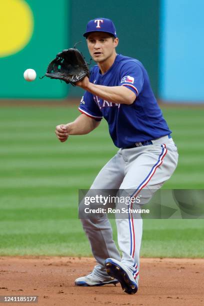 Corey Seager of the Texas Rangers fields the ball before throwing out Amed Rosario of the Cleveland Guardians at first base during the first inning...