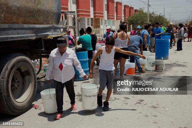 Residents queue to collect clean water from a tanker truck in Garcia municipality, northwest of the Monterrey metropolitan area, Nuevo Leon State,...