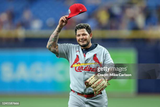 Yadier Molina of the St. Louis Cardinals acknowledges the crowd after pitching a scoreless eighth inning against the Tampa Bay Rays in a baseball...