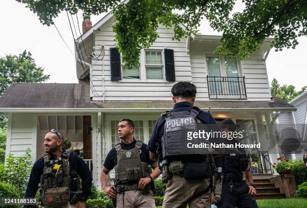 Law enforcement officers stand guard as protesters march past Supreme Court Justice Brett Kavanaugh's home on June 8, 2022 in Chevy Chase, Maryland....