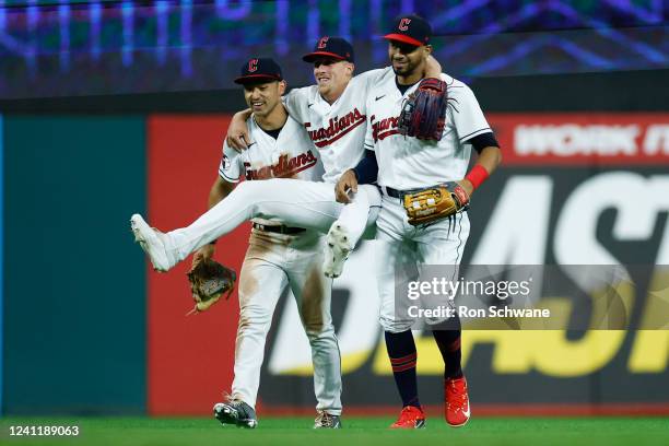 Steven Kwan, Myles Straw and Oscar Mercado of the Cleveland Guardians celebrate a 4-0 win against the Texas Rangers at Progressive Field on June 08,...