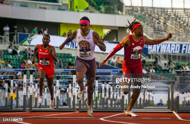 Eric Edwards of the LSU Tigers, center, wins his heat of the 110 hurdles as competes with DeVion Wilson of the Houston Cougars and TreBien Gilber of...