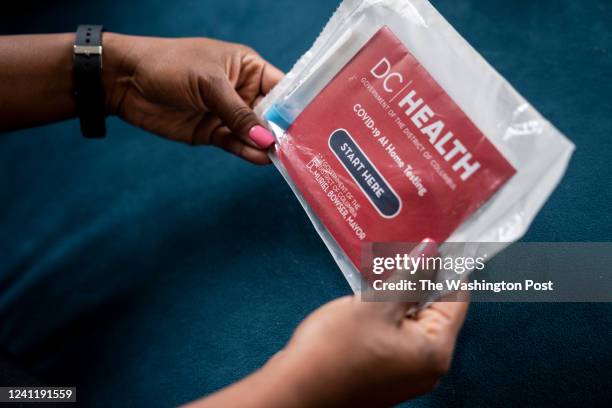 May 5 : Michelle Green, a project manager, holds an unused covid-19 test at her familys home in Washington, DC on May 5, 2022. By working from home...