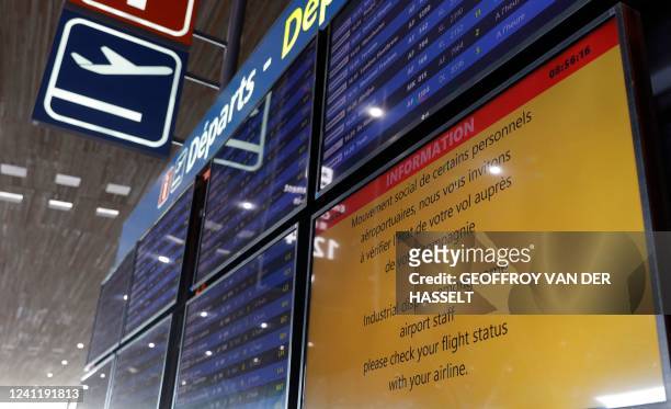 An screen displays a notification of travel disruptions as Paris Charles de Gaulle airport employees stage a strike to demand higher wages at Roissy...