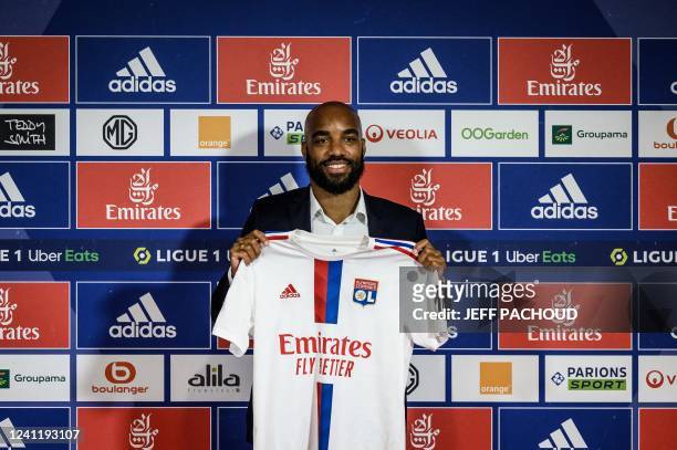 Former France international Alexandre Lacazette poses with his jersey during a press conference to announce his return to Ligue 1 Olympique Lyonnais...