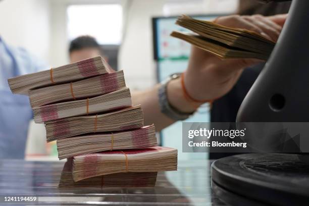 Bundles of Chinese yuan banknotes at the Ninja Money Exchange, operated by Interbank HD, in the Shinjuku district of Tokyo, Japan, on Thursday, June...