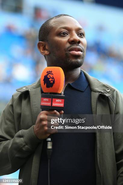 Shaun Wright-Phillips holds the microphone as he works for Astro Supersport television during the Premier League match between Manchester City and...