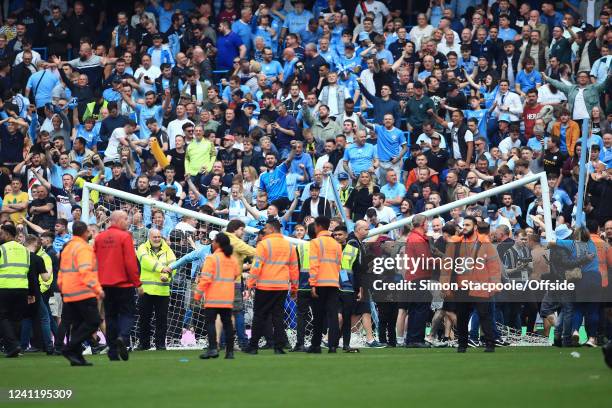 Fans damage the goal crossbar as they celebrate on the pitch after the Premier League match between Manchester City and Aston Villa at Etihad Stadium...