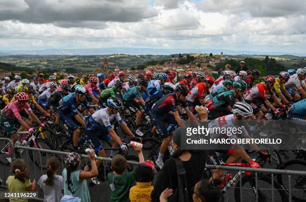 The pack of riders cycles during the fifth stage of the 74th edition of the Criterium du Dauphine cycling race, 162.5 km between Thizy-les-Bourgs and...