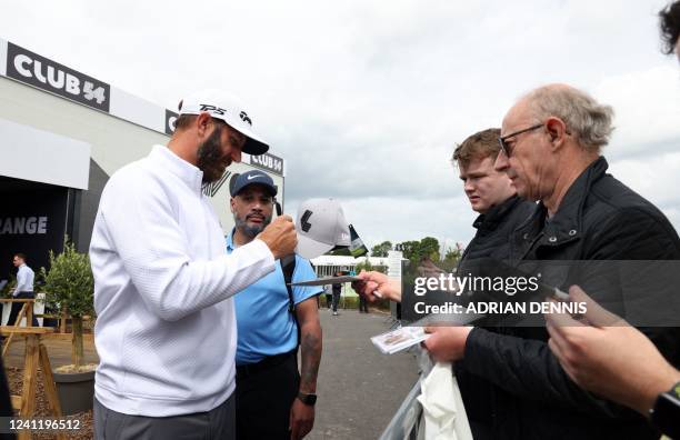 Golfer Dustin Johnson signs autographs on the first day of the LIV Golf Invitational Series event at The Centurion Club in St Albans, north of...