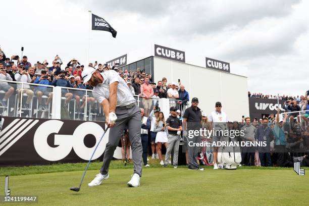 Golfer Dustin Johnson plays from the 1st tee on the first day of the LIV Golf Invitational Series event at The Centurion Club in St Albans, north of...