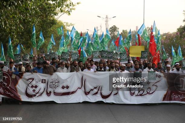 Pakistani Muslims hold a banner as they take part in a protest, organised by the Jamaat-e-Islami Party, against the remarks about the Prophet...