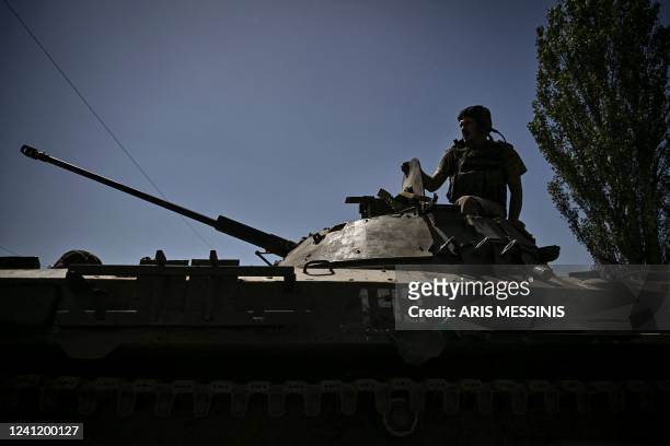 Member of the Ukrainian troops stands on an armoured vehicle moving towards the front line in the city of Lysychansk in the eastern Ukraine region of...