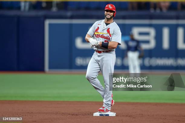 Albert Pujols of the St. Louis Cardinals laughs as he reaches second base on a pop fly against the Tampa Bay Rays during the second inning of a...