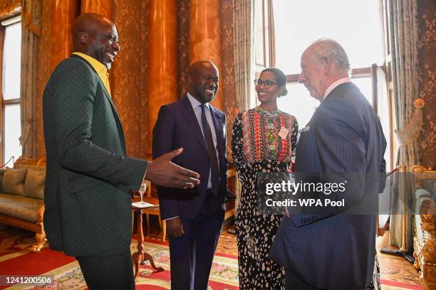 Prince Charles, Prince of Wales, speaks with fashion designer Ozwald Boateng and architect David Adjaye, while he attends a reception at Buckingham...