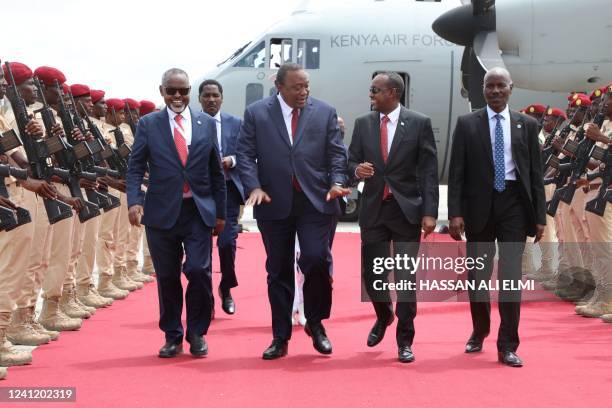 Somalia's Prime Minister Mohamed Hussein Roble welcomes Kenya's President Uhuru Kenyatta upon his arrival to attend the inauguration of the 10th...