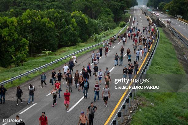 Migrants taking part in a caravan heading to the US, walk from Huixtla to Escuintla, Chiapas state, Mexico, on June 9, 2022. - Thousands of mostly...