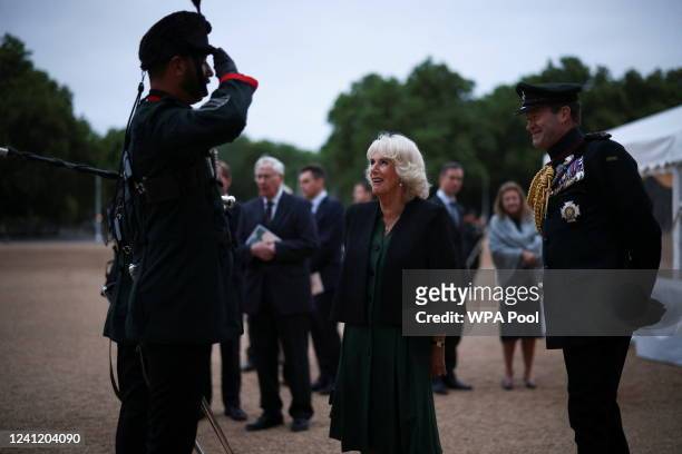 Camilla, Duchess of Cornwall talks to a member of The Band and Bugles of The Rifles attends the Rifles Sounding Retreat on June 9, 2022 in London,...