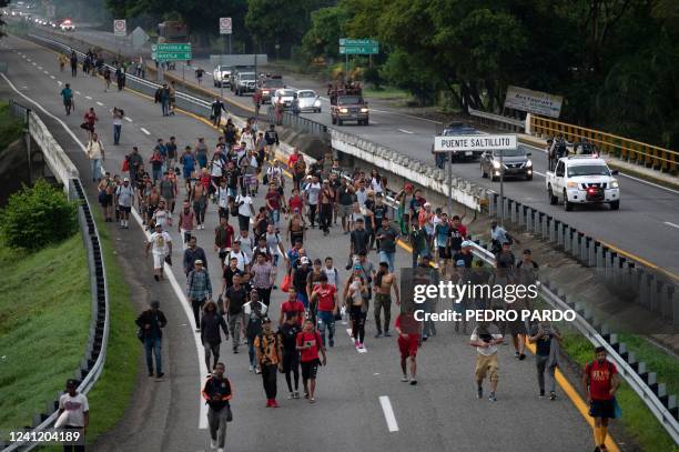 Migrants taking part in a caravan heading to the US, walk from Huixtla to Escuintla, Chiapas state, Mexico, on June 9, 2022. - Thousands of mostly...
