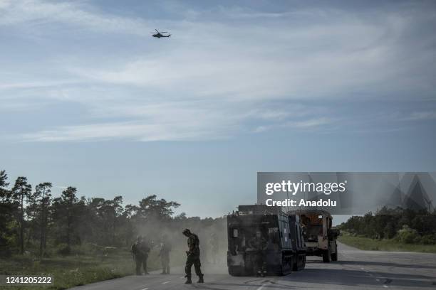 Helicopter flies above as US and Swedish troops take part of a war simulation called âthe battle of Broâ during the Baltops 22, the Balticâs year...