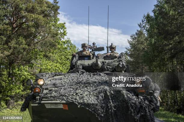 Marines wait for aerial support alongside a road in Bro area as US and Swedish troops take part of a war simulation called âthe battle of Broâ...