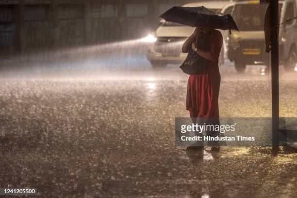 Citizens caught up in heavy rain at Kherwadi, Bandra on June 9, 2022 in Mumbai, India. The city on Thursday evening experienced its heaviest and...