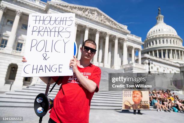 Demonstrator holds a sign referencing calls for legislation to address gun violence is seen outside the U.S. Capitol on Thursday, June 9, 2022.