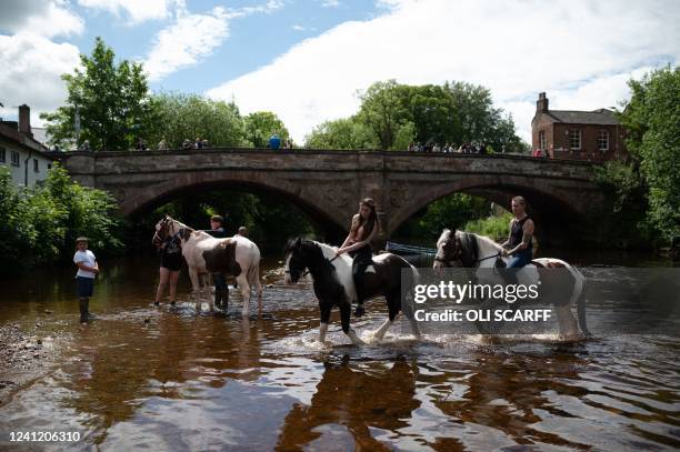 People wash horses in the River Eden on the first day of the annual Appleby Horse Fair, in the town of Appleby-in-Westmorland, north west England on...