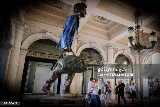 This picture taken on June 8, 2022 in Venice show a sculpture by artist Bruno Catalano at Piazza San Marco. / RESTRICTED TO EDITORIAL USE - MANDATORY...