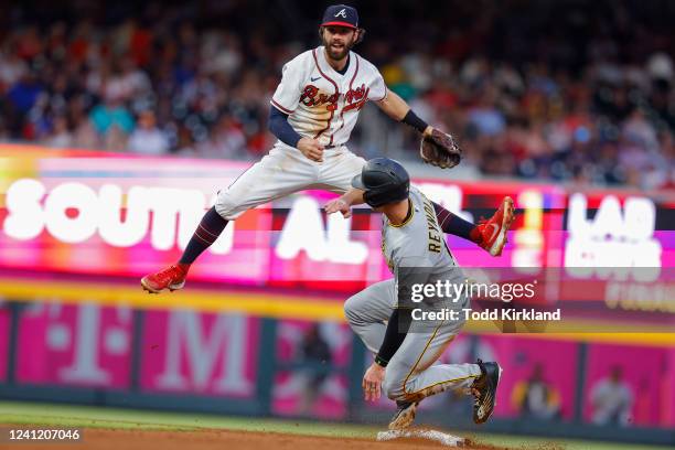 Bryan Reynolds of the Pittsburgh Pirates is forced out at second as Dansby Swanson of the Atlanta Braves turns a double play during the fifth inning...