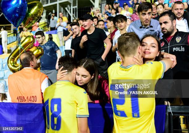 Ukraine's Dmytro Kryskiv and Artem Bondarenko greet their relatives at the end of the UEFA European Under-21 Championship Qualifier Group H between...