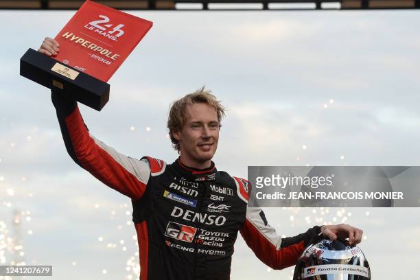 New Zeland's driver Brendon Hartley reacts after receiving the Hyperbole trophy after the Hyperpole practice session on his Toyota GR010 Hybrid...