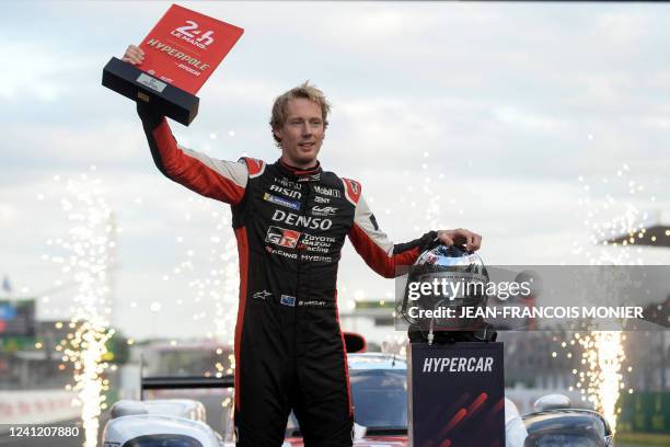 New Zeland's driver Brendon Hartley reacts after receiving the Hyperbole trophy after the Hyperpole practice session on his Toyota GR010 Hybrid...