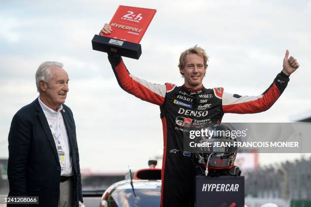 New Zeland's driver Brendon Hartley celebrates next to former racing driver Gerard Larrousse as he receives the Hyperbole trophy after the Hyperpole...