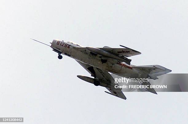 Chinese fighter flies through the sky over Haikou, on China's southern Hainan island, 10 April 2001, where 24 crew members of a United States...