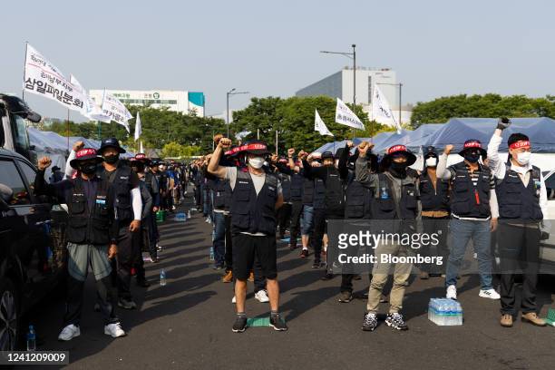 Truck drivers and members of the Korean Confederation of Trade Unions shout slogans during a demonstration in front of the Uiwang Inland Container...