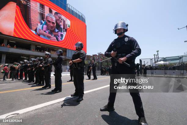 Police officers clear the street during a protest outside the Convention Center where the 9th Summit of the Americas takes place in Los Angeles,...