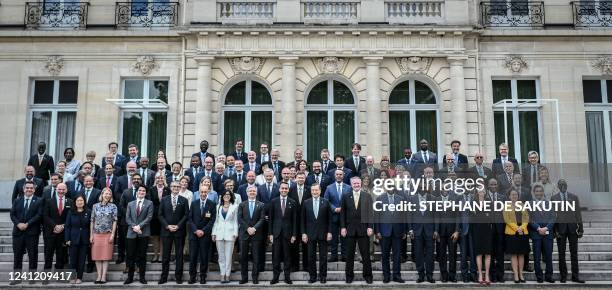 Members and Ministers pose for a family picture on the sidelines of a ministerial meeting at the Organisation for Economic Co-operation and...