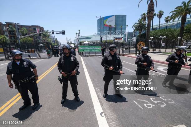 Police officers clear the street during a protest outside the Convention Center during the 9th Summit of the Americas in Los Angeles, California,...