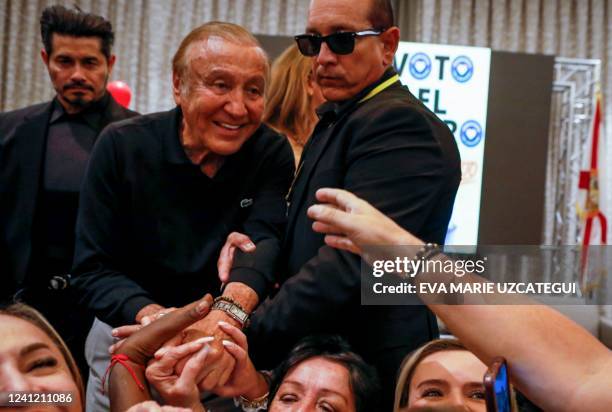 Colombian presidential candidate Rodolfo Hernandez greets attendees during a gathering with the Colombian community in Miami, Florida, on June 9,...