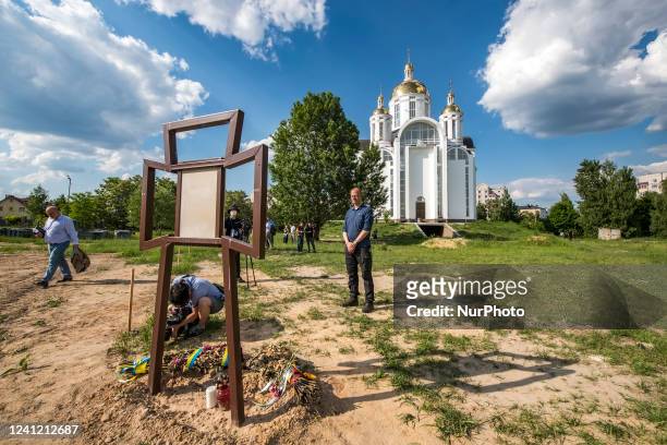 Michael Brand , German MP, stands near memorial on the location of a mass grave in Bucha during the visit of a delegation of lawmakers of the...