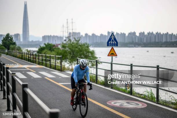 Man cycles along the Han River in Seoul on June 10, 2022.