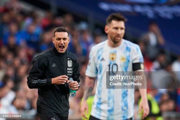 Lionel Scaloni head coach of Argentina gives instructions to Lionel Messi of Argentina during the Finalissima 2022 match between Argentina and Italy...