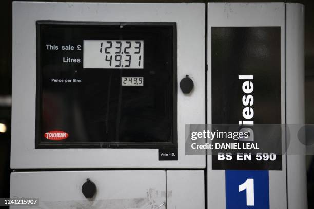 Petrol pump shows the price in pounds sterling of £123.23, over one hundred pounds, for 49.31 litres of fuel on a Diesel fuel pump, where Diesel is...