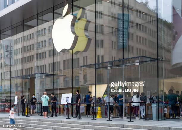 People enter an Apple Store in Shanghai on June 10 as Shanghai will carry out a city wide Covid-19 testing in the coming weekend. - China OUT / China...