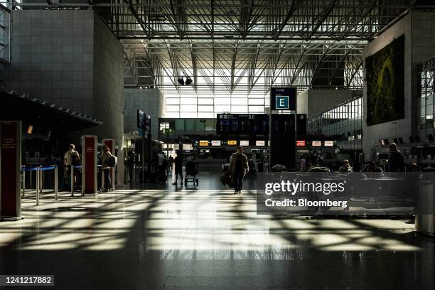 Travelers in a near-empty departures hall at Terminal 2 of Frankfurt Airport in Frankfurt, Germany, on Friday, June 10, 2022. Deutsche Lufthansa AG...