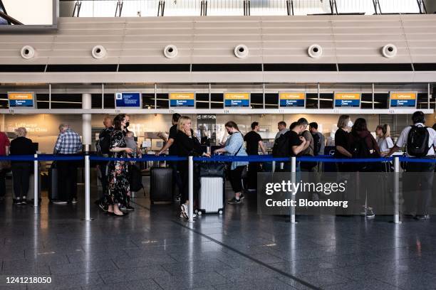 Travelers queue at Deutsche Lufthansa AG check in counters in the departures hall at Terminal 1 of Frankfurt Airport in Frankfurt, Germany, on...