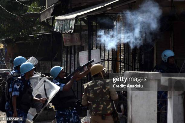 Indian Security personnel use tear gas to disperse protestors during a protest over insulting remarks against Prophet Muhammad by some officials of...