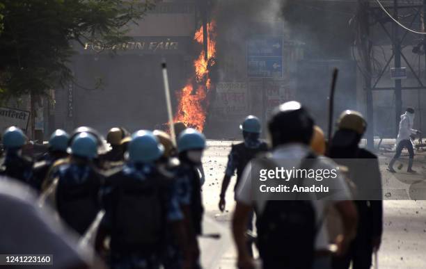 Protestors clash with Indian Security personnel during a protest over insulting remarks against Prophet Muhammad by some officials of the Indian...