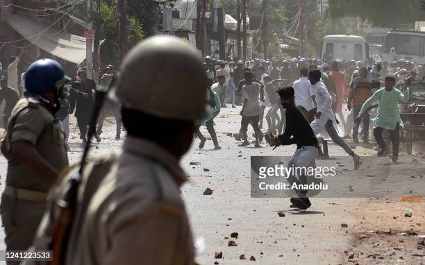 Protestors throw stones towards Indian Security personnel during a protest over insulting remarks against Prophet Muhammad by some officials of the...